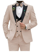 A slim fit beige three-piece tuxedo suit with a black peak lapel and matching bow tie.