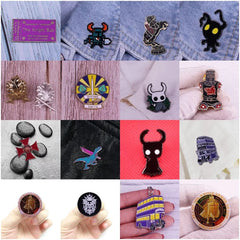 A collection of various enamel lapel pins featuring fantasy, gaming, and religious designs.