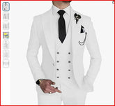 A man wearing a white three-piece suit with a black tie and a decorative lapel pin.