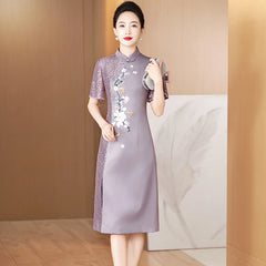 A woman wears a purple satin cheongsam with short lace sleeves, floral embroidery, and bead accents.