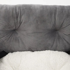 A grey plush pet car seat cushion with a soft white interior lining.