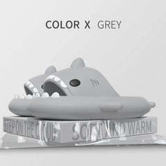 A pair of grey shark-shaped EVA slides sitting on a platform labeled with text.