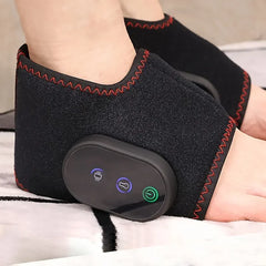 A person wears a black, wireless electric foot massager with red stitching and a control panel.