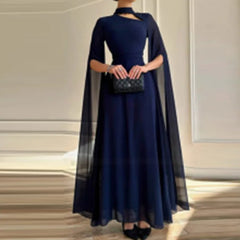 A navy blue floor-length gown featuring a high neckline with a cutout and sheer cape sleeves.