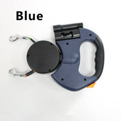 A blue retractable double dog leash with an integrated flashlight and waste bag dispenser.