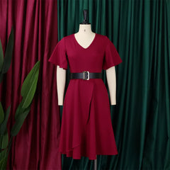 A burgundy midi dress with butterfly sleeves and a black belt on a mannequin.