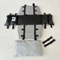 A grey and black portable car pet seat with side bolsters, a cushion, and two adjustable straps.
