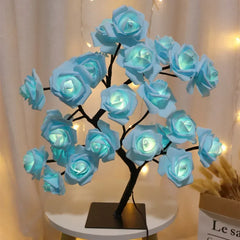 A decorative LED lamp shaped like a tree with light blue rose blossoms on adjustable branches.