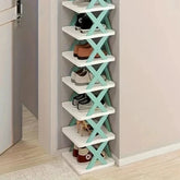 A tall, multi-layered white shoe rack with teal X-shaped supports standing against a wall.