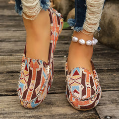 Women's slip-on loafers featuring a colorful geometric fabric pattern and round toes.