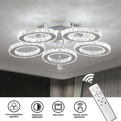 A modern chrome flush-mount chandelier with five crystal-encrusted rings and a remote control.