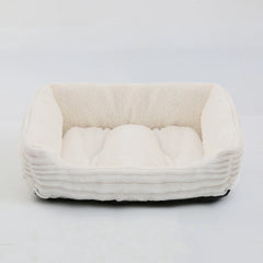A rectangular, cream-colored plush pet bed with raised sides and a ribbed exterior.