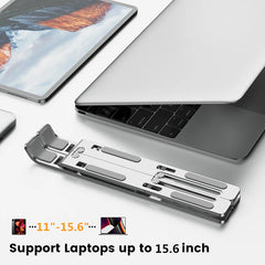 A foldable silver aluminum laptop stand shown next to a laptop and tablet.