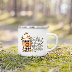 A white enamel camping mug featuring a pumpkin spice latte graphic with fall-themed text.