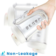 A hand holds a clear plastic protein shaker bottle with a white lid and a carrying strap.