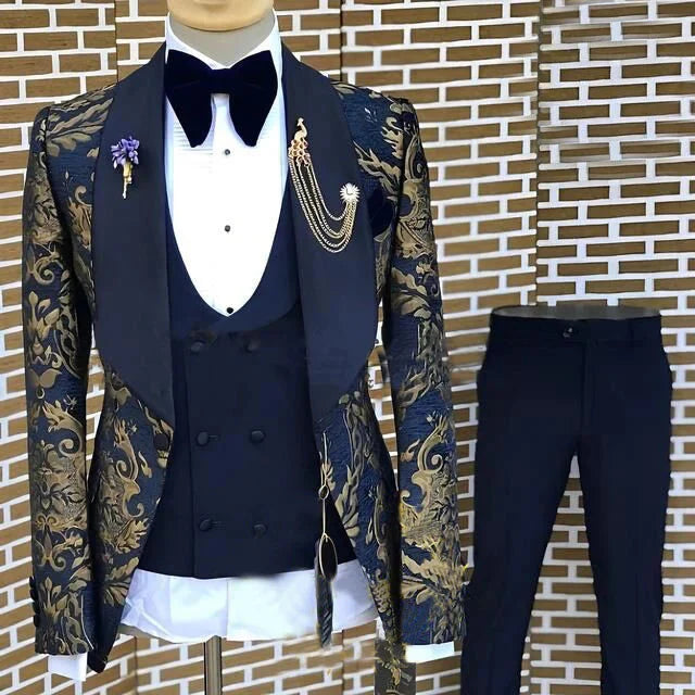 A three-piece men's suit featuring a navy and gold floral jacquard blazer, a navy vest, and trousers.