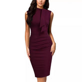 A woman wears a sleeveless, knee-length, solid burgundy pencil dress with a bow at the neckline.