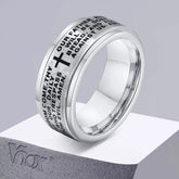 A silver stainless steel spinner ring engraved with a cross and the Lord's Prayer.