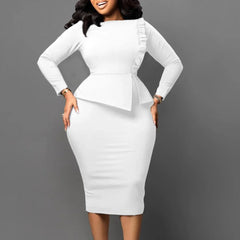 A woman wears a white long-sleeved sheath dress with a peplum waist and mid-calf length.