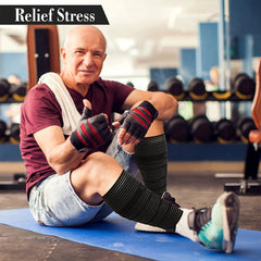 A man in a gym wears black elastic compression bandages wrapped around his lower legs.