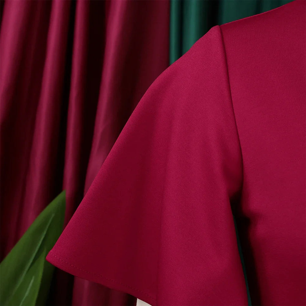 A close-up view of the magenta butterfly sleeve on a solid-colored dress.