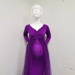 A purple long-sleeved maternity dress with a V-neck and a sheer tulle overlay.