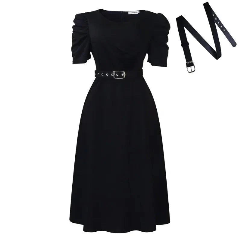A black midi-length A-line dress with puffed short sleeves and a matching buckled belt.