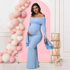 A pregnant woman wears a light blue, off-shoulder, long-sleeve mermaid maternity dress.