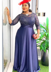 A woman wears a navy blue floor-length gown with a sequined bodice and a satin skirt.