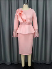A pink midi dress with a peplum waist, ruffled shoulder detail, and sequined bell cuffs.