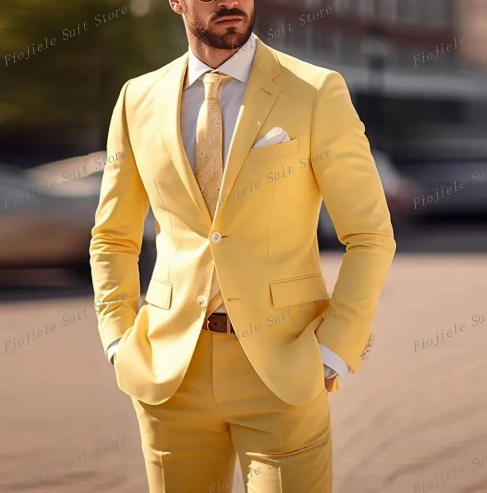 A man wears a yellow two-piece suit with a white shirt and a patterned yellow tie.