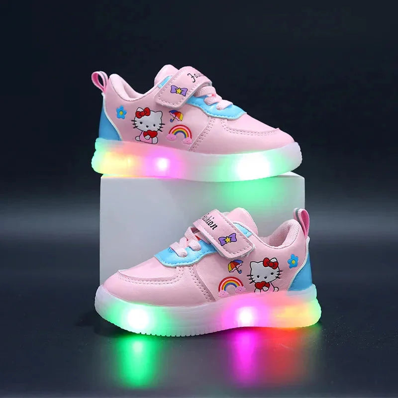 A pair of pink Hello Kitty sneakers for girls with light-up soles and hook and loop closures.