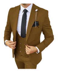 A man wears a slim-fit, three-piece brown suit with a white shirt and a polka-dot tie.
