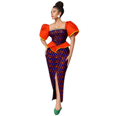 A woman wears an ankle-length Ankara print dress with puff sleeves and a square neckline.