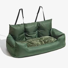 A green, rectangular pet car seat with a plush interior and adjustable straps for securing.