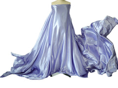 A mannequin displays a long, flowing piece of lavender satin fabric used for maternity photography.