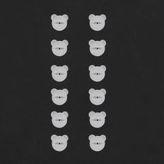 Twelve small, white, bear-shaped plastic fasteners arranged in two vertical columns.