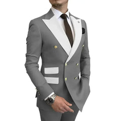 A man wears a grey double-breasted suit with white lapels and pocket flaps.