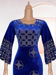 A royal blue velvet maxi dress featuring intricate rhinestone patterns and laser-cut details.