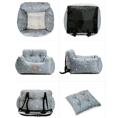 A grey pet car seat with a star and moon pattern, featuring adjustable straps and a removable cushion.