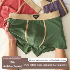 A pair of green cotton boxer shorts with a textured jacquard pattern and a tan waistband.