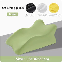 A green memory foam prone position pillow with a contoured shape measuring 55 by 36 by 23 cm.