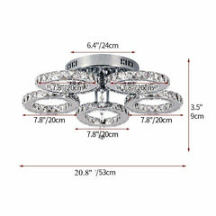 A modern chrome flush mount ceiling light featuring five circular crystal-encrusted rings.