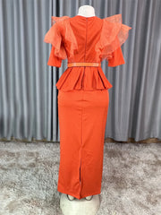 A back view of an orange ankle-length dress with ruffled sleeves, a peplum waist, and a belt.