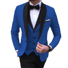 A man wears a royal blue three-piece tuxedo featuring a black shawl lapel and a black bow tie.