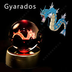 A glass crystal ball featuring a 3D laser-etched Gyarados figure illuminated by a red LED base.