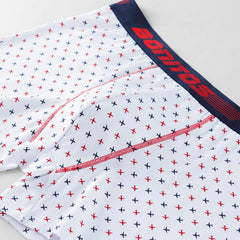 White men's boxer shorts featuring a repeating pattern of small red and blue airplanes.