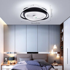 A modern black and white circular ceiling fan with an integrated LED light installed in a bedroom.