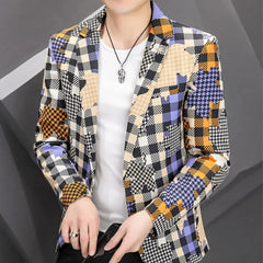 A man wears a slim-fit blazer featuring a multicolored patchwork pattern of plaid and houndstooth.