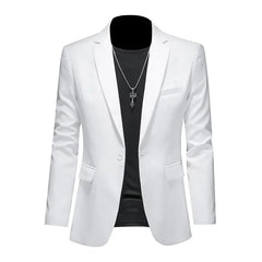 A white single-breasted blazer for men worn over a black t-shirt with a silver pendant necklace.